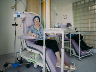 Deux patientes assises dans des fauteuils pendant leur cure de chimiothérapie